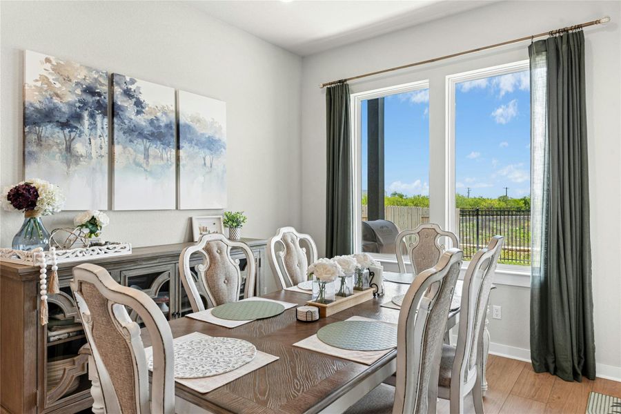 Dining area featuring light wood-style flooring and baseboards