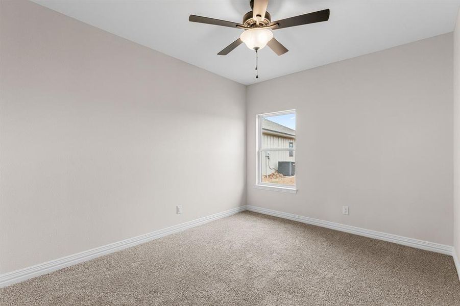 Carpeted spare room featuring ceiling fan Carpeted spare room featuring ceiling fan
