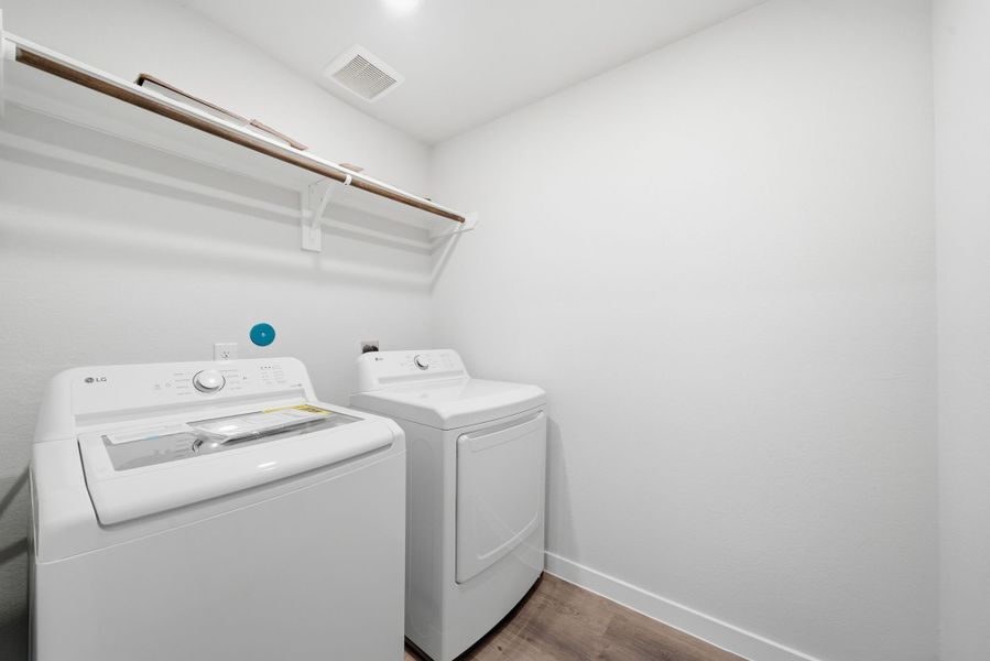 A washing machine in a room. A washing machine in a room.