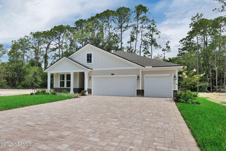 Front exterior of a new home in Creighton Pointe, Fleming Island, FL, highlighting curb appeal (Image 2). Front exterior of a new home in Creighton Pointe, Fleming Island, FL, highlighting curb appeal (Image 2).