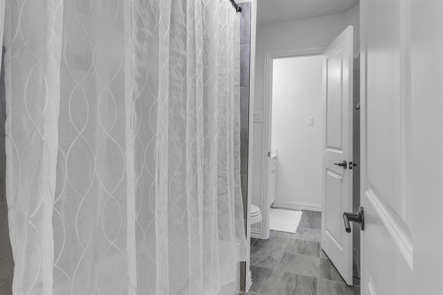 Bathroom with tile patterned flooring and toilet