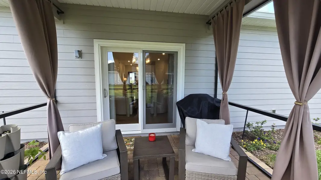 Exterior details and patio area of a home in Edenbrooke at Hyland Trail | 55+, Green Cove Springs (Image 24).