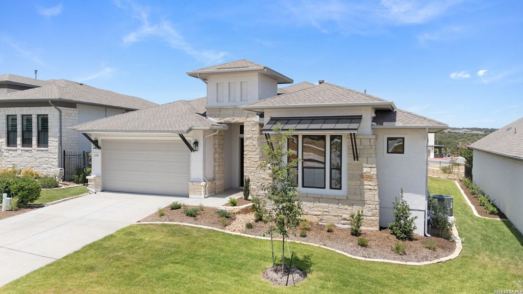 Front exterior of a new home in El Sonido at Campanas, San Antonio, TX, highlighting curb appeal (Image 2). Front exterior of a new home in El Sonido at Campanas, San Antonio, TX, highlighting curb appeal (Image 2).