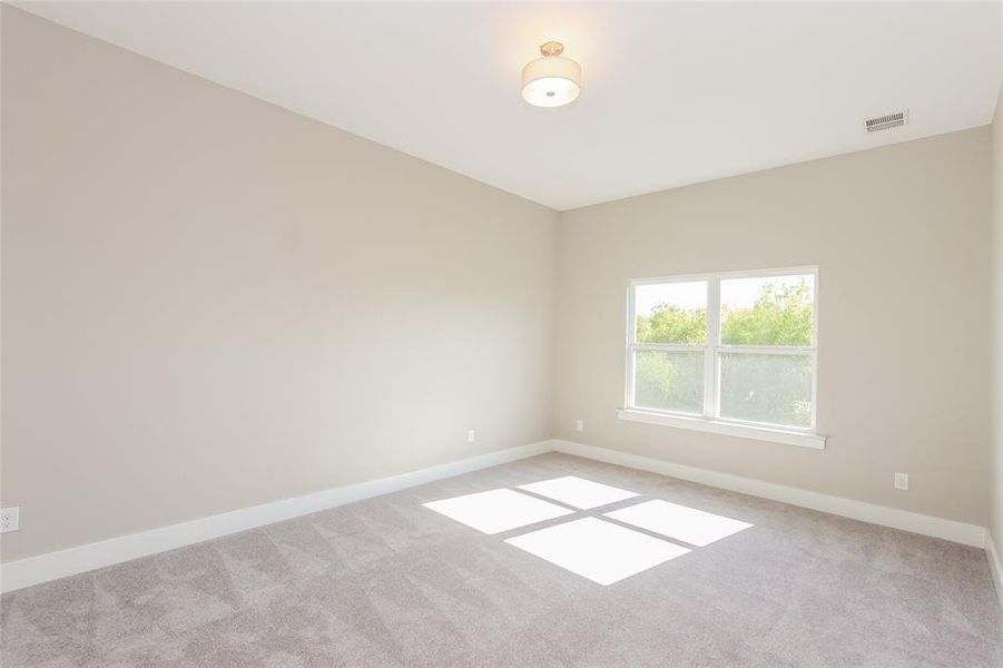 Spare room featuring light colored carpet