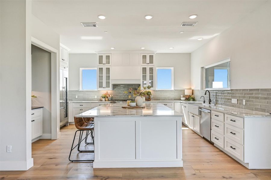 This stunning kitchen combines luxury finishes with high performance functionality including Thermador appliances, a 6 burner range, and oversized island seating. Open sightlines make it the ultimate gathering space.