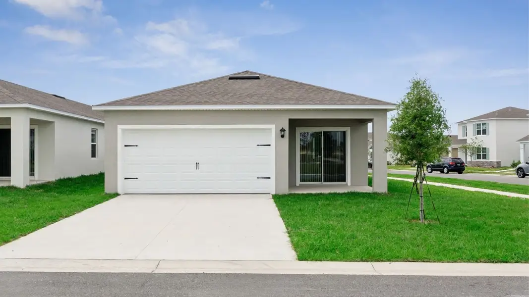 Front exterior of a new home in Crossroads at Kelly Park, Apopka, FL, highlighting curb appeal (Image 2).