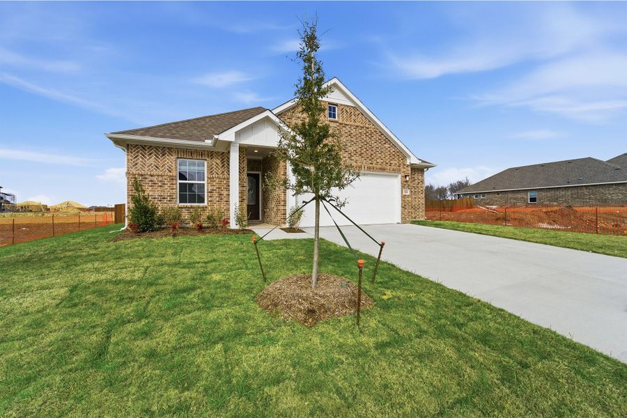Front exterior of a new home in Saddlebrook Estates, Waxahachie, TX, highlighting curb appeal (Image 26). Front exterior of a new home in Saddlebrook Estates, Waxahachie, TX, highlighting curb appeal (Image 26).