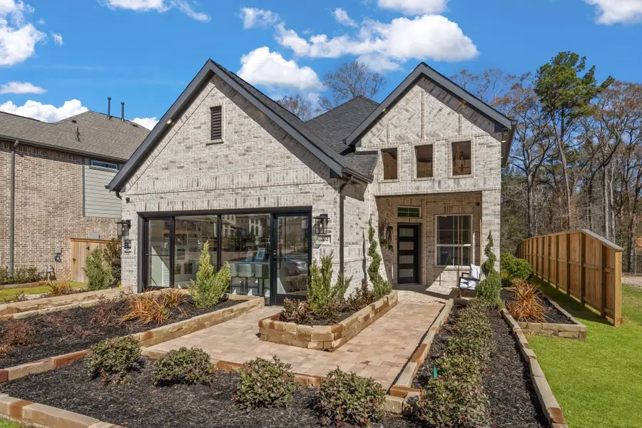 Front exterior of a new home in The Woodlands Hills, Willis, TX, highlighting curb appeal (Image 1). Front exterior of a new home in The Woodlands Hills, Willis, TX, highlighting curb appeal (Image 1).