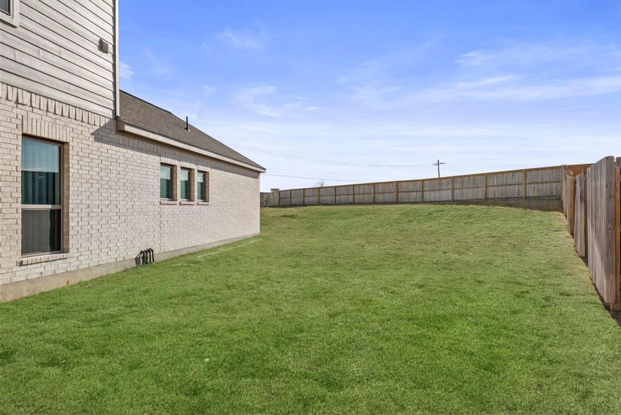View of fenced backyard