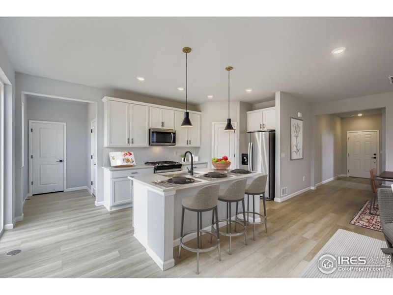 Chef's kitchen with sleek countertops and a pantry