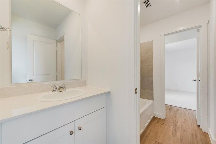 Bathroom with vanity and hardwood / wood-style flooring