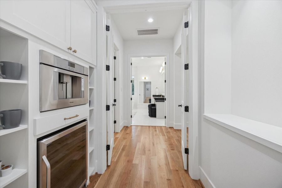 Built in Thermador coffee station and beverage refrigeration create a dedicated morning and entertaining corridor just outside the primary suite. Open shelving, integrated storage, and easy access to the game room and bedrooms keep daily routines efficient while elevating the upstairs experience. Built in Thermador coffee station and beverage refrigeration create a dedicated morning and entertaining corridor just outside the primary suite. Open shelving, integrated storage, and easy access to the game room and bedrooms keep daily routines efficient while elevating the upstairs experience.