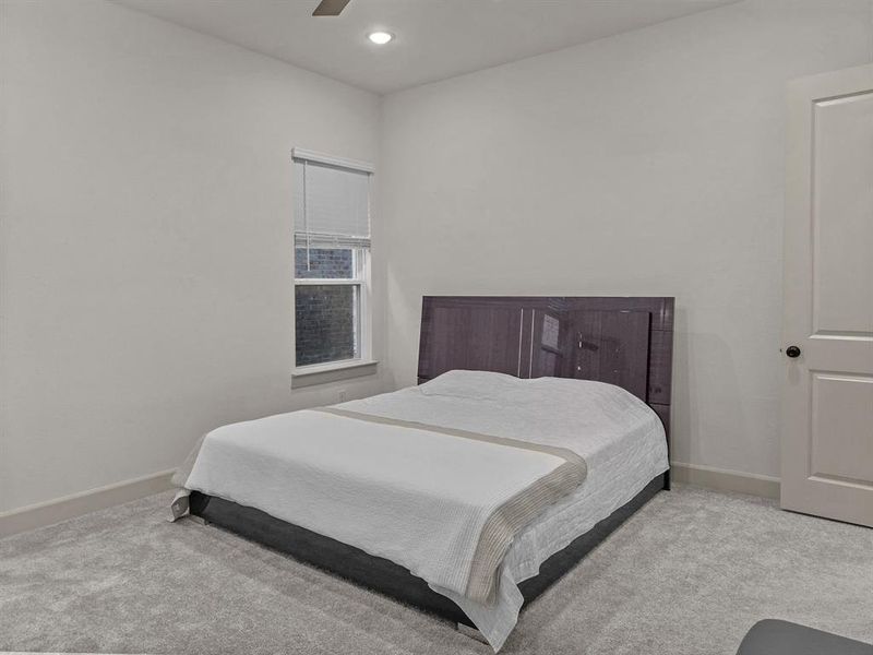 Master Bedroom with ceiling fan and light colored carpet