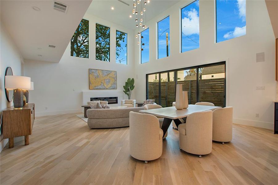 Living room featuring a high ceiling and light wood-type flooring