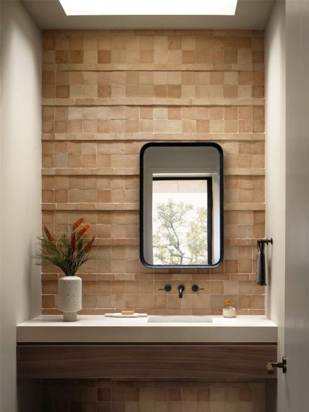 Powder bath with Clé tile backsplash, under cabinet lighting, backlit mirror to shine on the tiles in the evening, and skylight for natural light in the day.