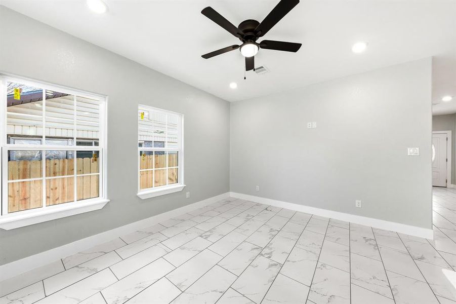 Unfurnished room featuring light marble finish flooring, a ceiling fan, and recessed lighting