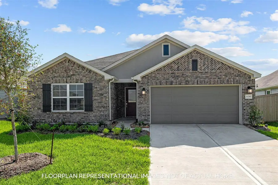 Front exterior of a new home in Pinewood at Grand Texas, New Caney, TX, highlighting curb appeal (Image 2).