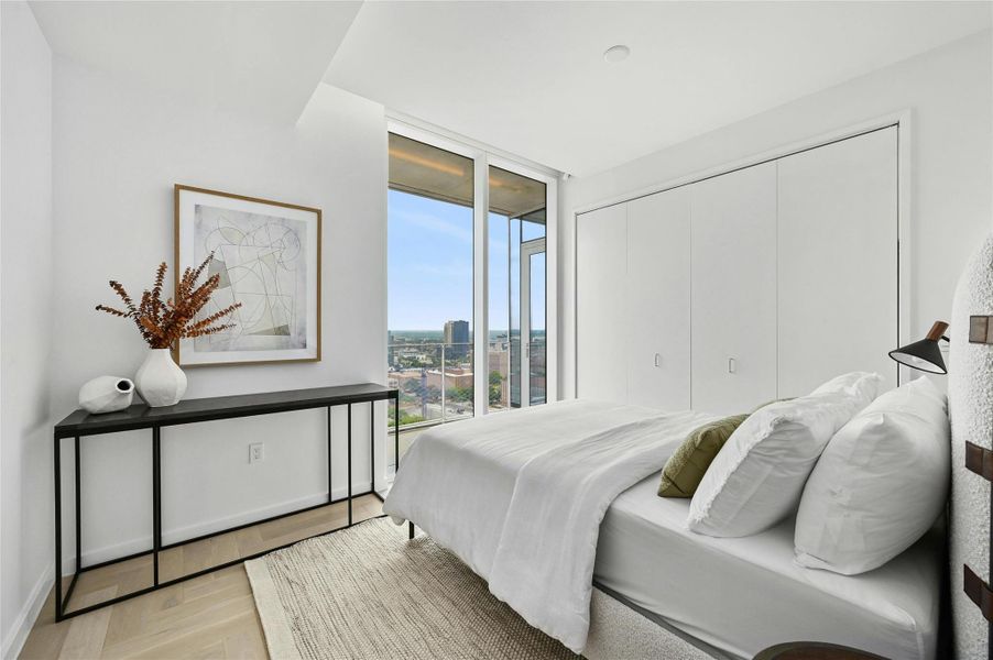 The second bedroom offers ample storage space and features a glass panel view terrace, providing a blend of functionality and scenic views. *Linden Residence No. 2107 Furnished Model Shown Here