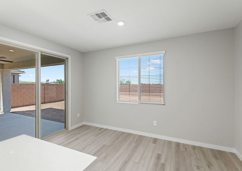 The living area is filled with natural light from sliding glass doors.