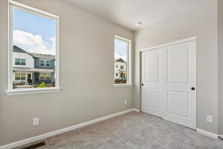 A room with white doors and a window.