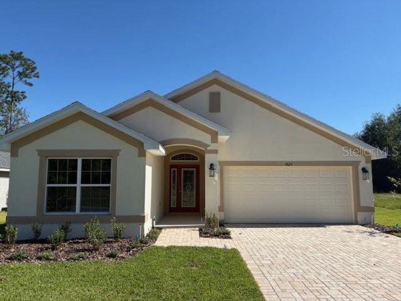 Front exterior of a new home in Juliette Falls, Dunnellon, FL, highlighting curb appeal (Image 1). Front exterior of a new home in Juliette Falls, Dunnellon, FL, highlighting curb appeal (Image 1).