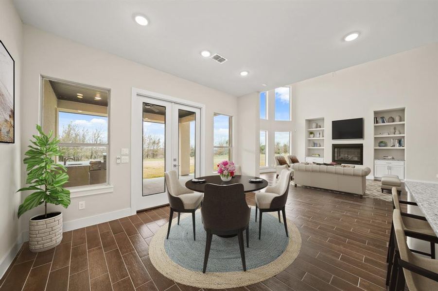 Virtually Staged: Charming breakfast area, complete with tile floors, recessed lighting, and beautiful views of the backyard provided by several windows.