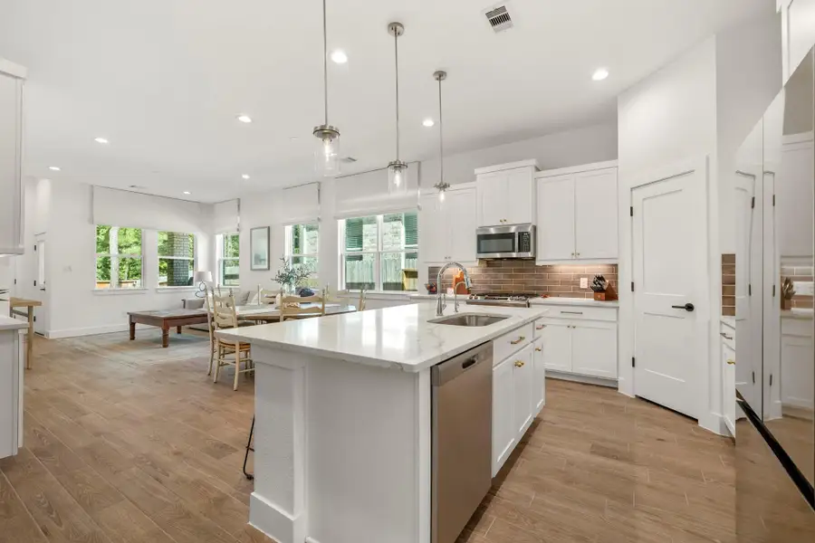 An open layout connects to a bright dining area with large windows offering abundant natural light. Perfect for entertaining and family gatherings. An open layout connects to a bright dining area with large windows offering abundant natural light. Perfect for entertaining and family gatherings.