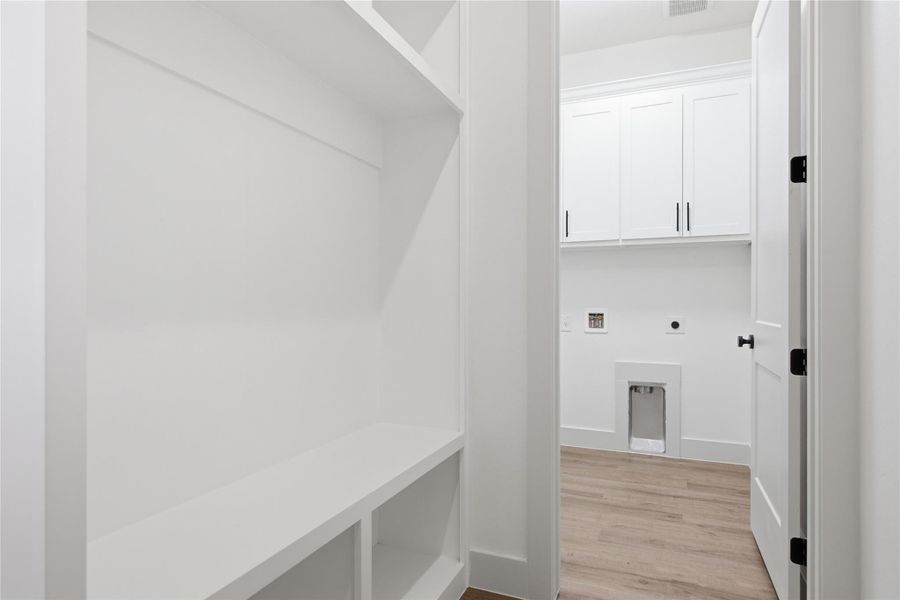 Ample built-in shelving provides practical storage in this well-appointed utility area. Ample built-in shelving provides practical storage in this well-appointed utility area.