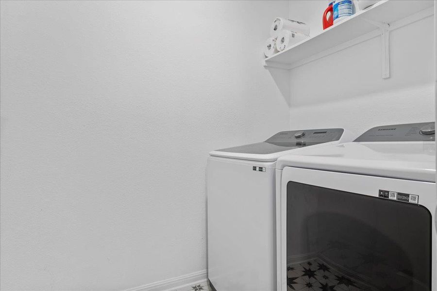 Laundry room with washing machine and dryer and baseboards