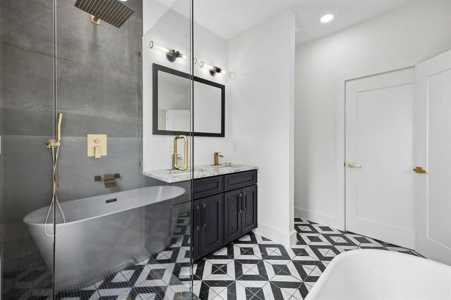 Freestanding soaking tub with gold-tone fixtures and rain shower head Freestanding soaking tub with gold-tone fixtures and rain shower head