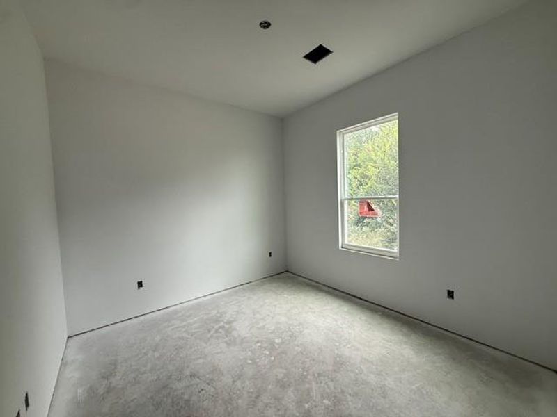 A quiet space awaits customization, offering potential with an outdoor view.