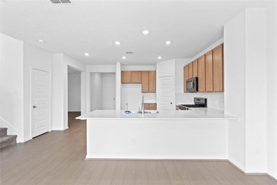 This spacious kitchen has it all—ample storage, generous counter space, and a layout that truly makes it the heart of the home.