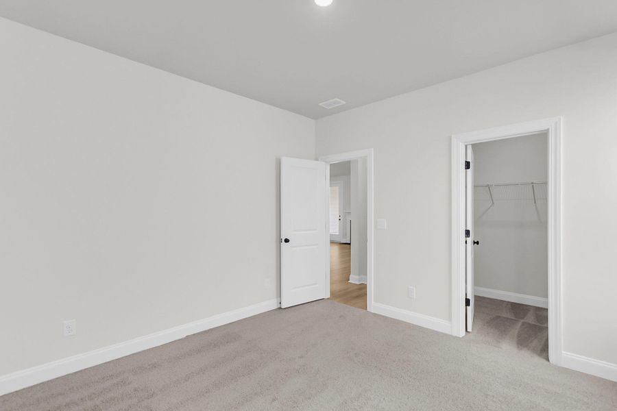 Spacious, unfurnished interior of a new home in Tidewater at Lakes of Cane Bay, Summerville (Image 32).