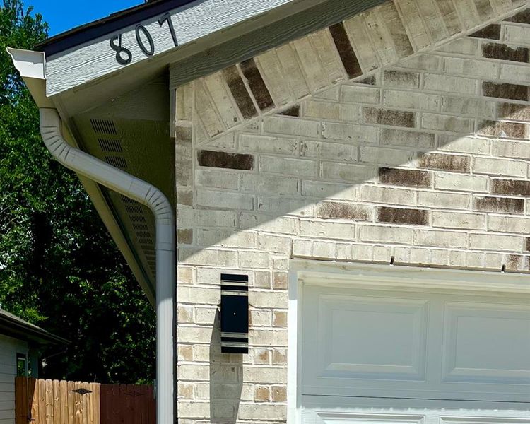 Full bathroom with a shower stall, double vanity, wood finished floors, and a walk in closet Full bathroom with a shower stall, double vanity, wood finished floors, and a walk in closet
