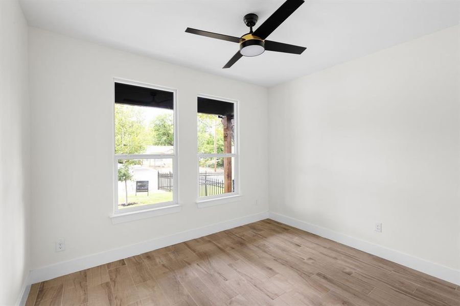 Empty room featuring ceiling fan and light hardwood / wood-style floors