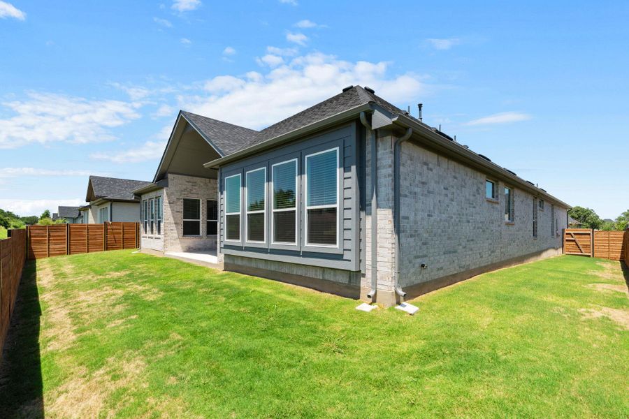 A well-maintained lawn extends around this elegant home.