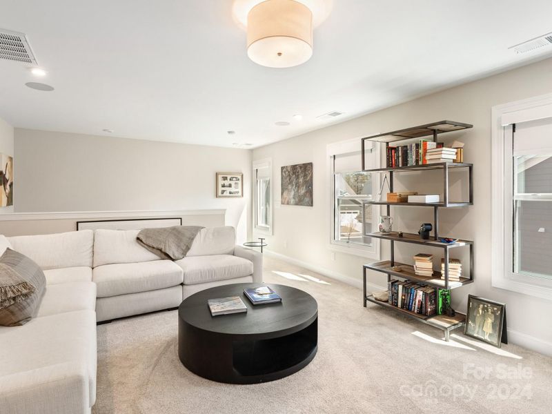 Second story recreational room with black out shades for movie watching and a full bathroom