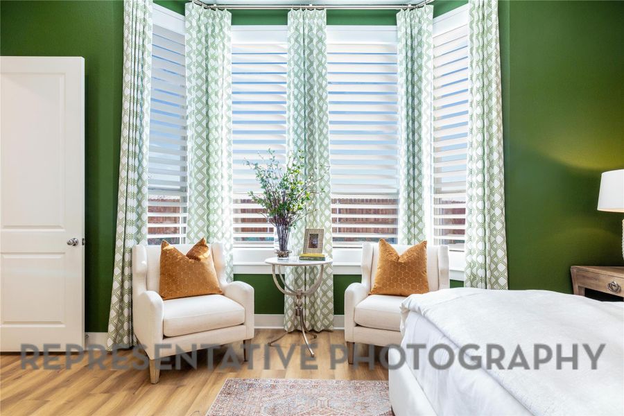 Bedroom with multiple windows and wood finished floors Bedroom with multiple windows and wood finished floors