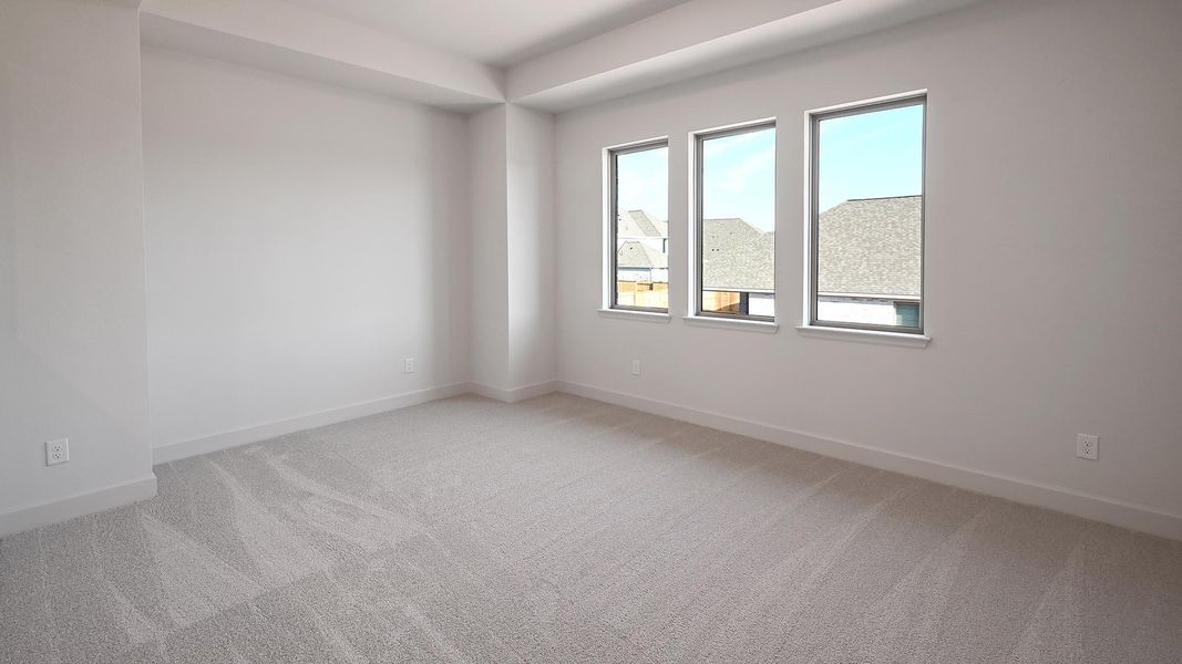 Spare room with light colored carpet and baseboards Spare room with light colored carpet and baseboards