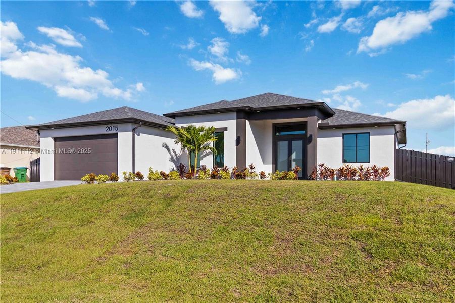 Front exterior of a new home in , Cape Coral, FL, highlighting curb appeal (Image 1). Front exterior of a new home in , Cape Coral, FL, highlighting curb appeal (Image 1).