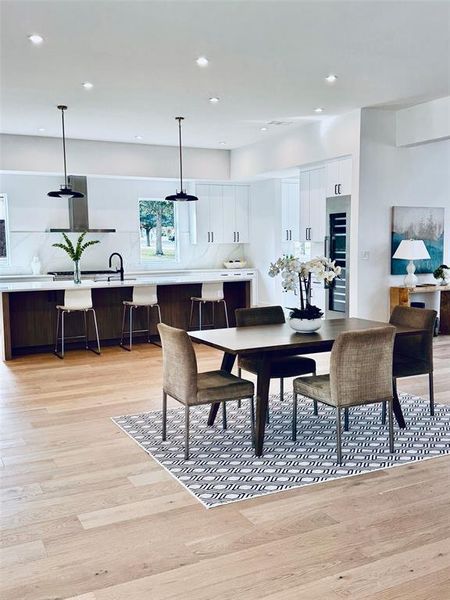 Dining space with light wood-type flooring and sink