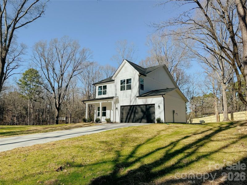 Front exterior of a new home in , Huntersville, NC, highlighting curb appeal (Image 19).
