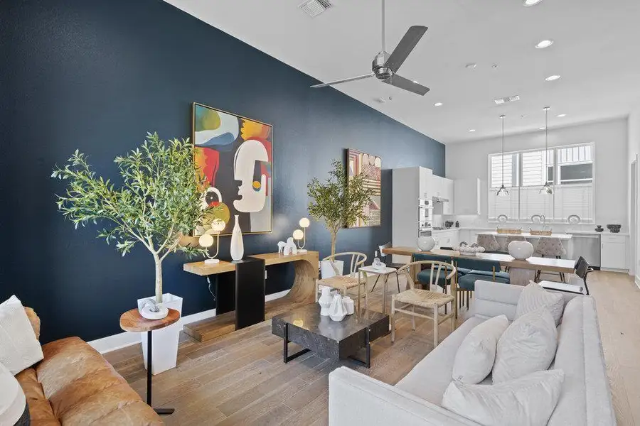 Living area featuring light wood-style flooring and a ceiling fan