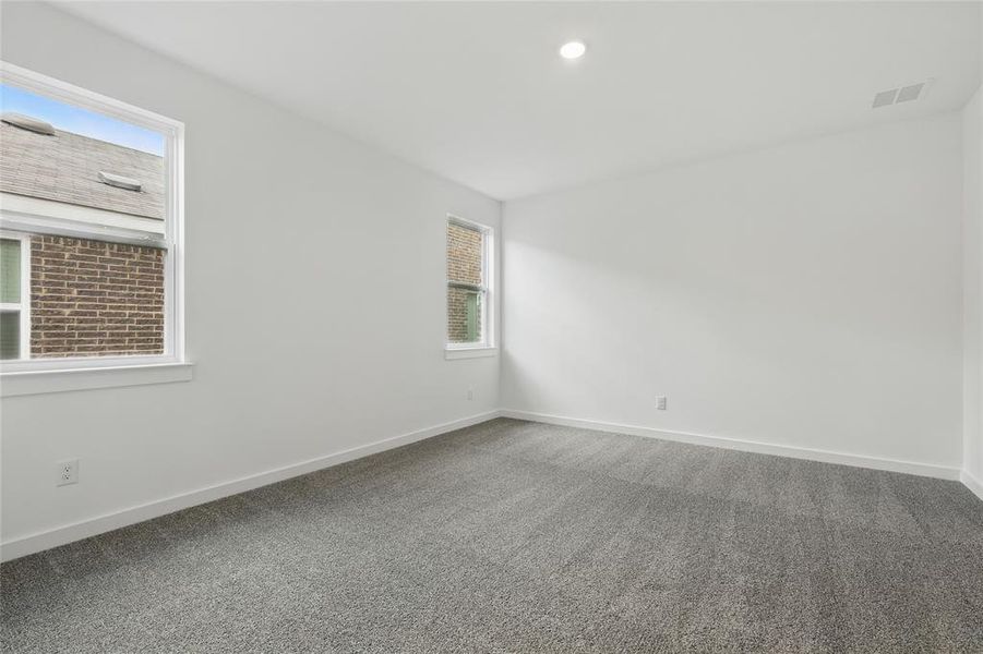 Carpeted spare room featuring baseboards and recessed lighting