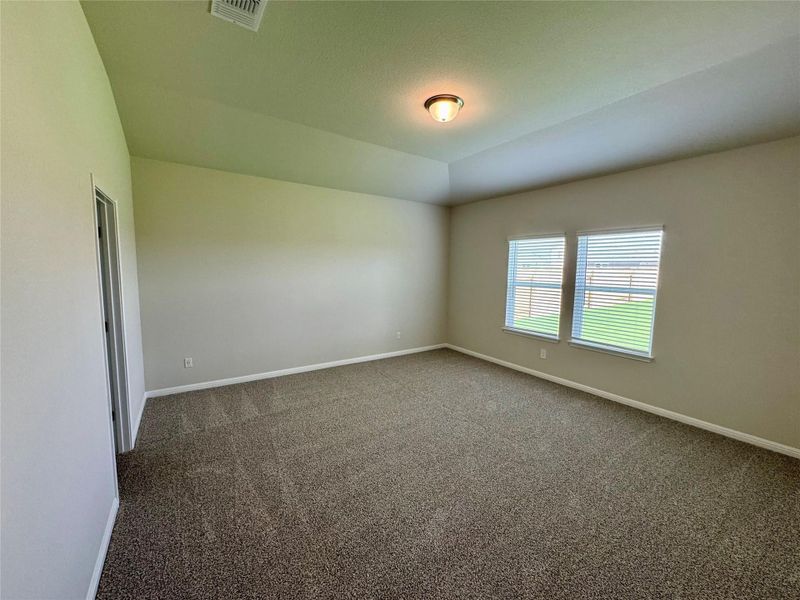 Unfurnished room featuring dark carpet and baseboards Unfurnished room featuring dark carpet and baseboards