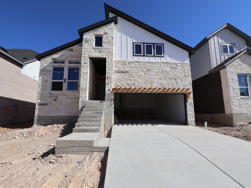 Front exterior of a new home in Cedar Brook, Leander, TX, highlighting curb appeal (Image 1).