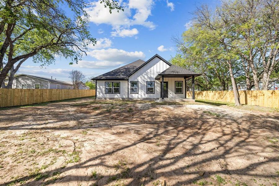 Unfurnished dining area with light marble finish flooring, a chandelier, and lofted ceiling
