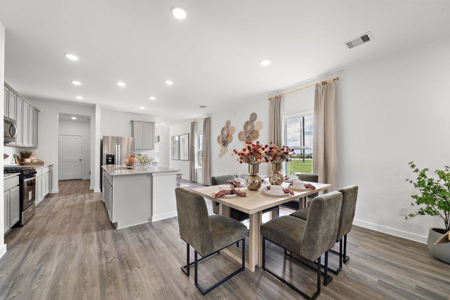 A dining room with a table and chairs. A dining room with a table and chairs.