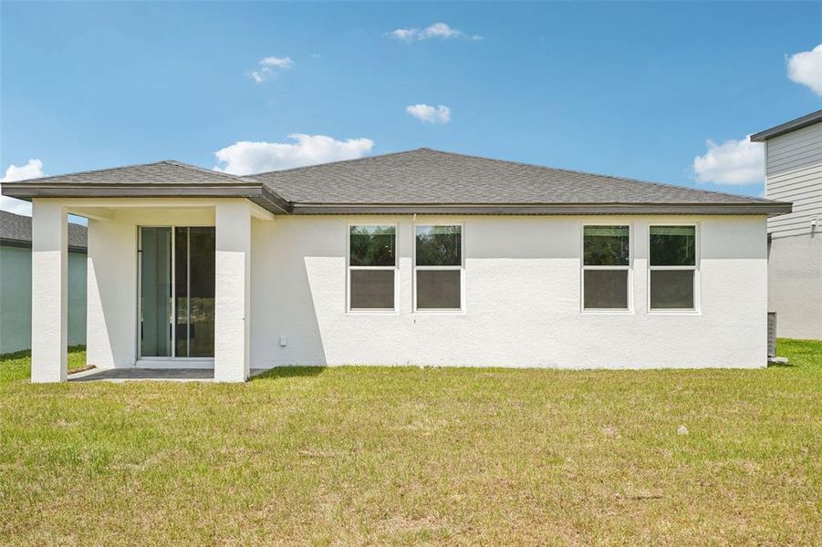 Exterior details and patio area of a home in The Reserve at Hammock Oaks - Signature Series, Lady Lake (Image 3).