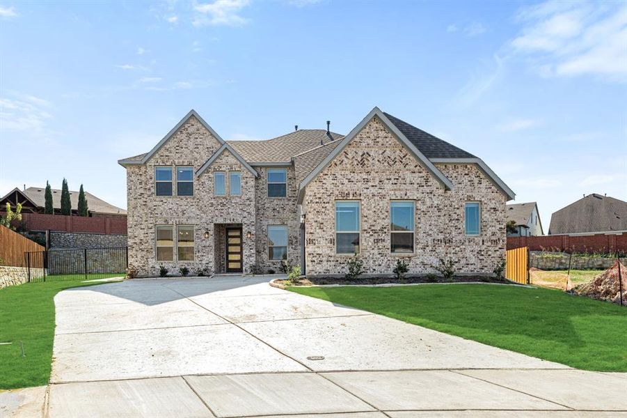 Front exterior of a new home in The Enclave at Parks of Aledo, Aledo, TX, highlighting curb appeal (Image 2). Front exterior of a new home in The Enclave at Parks of Aledo, Aledo, TX, highlighting curb appeal (Image 2).